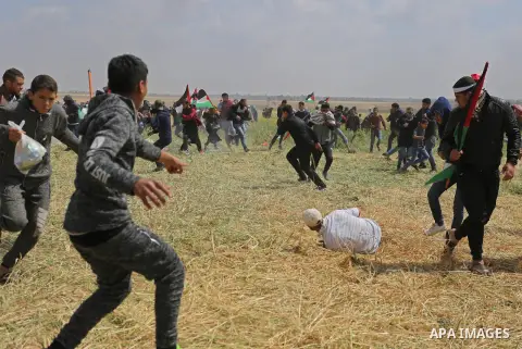A wounded Palestinian is evacuated during clashes with Israeli security forces during a tent city protest along the Israel border with Gaza, demanding the right to return to their homeland, in Khan Younis in the southern...