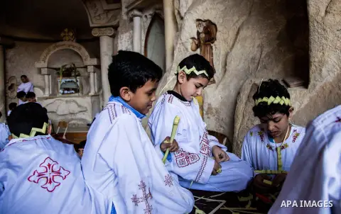 Egyptian Orthodox Christians take part in a mass marking the Palm Sunday at a church in Saint Samaan the tanner Monastery in Cairo on April 1, 2018. Photo by Stringer