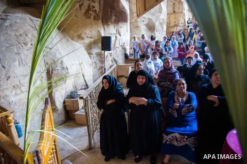 Egyptian Orthodox Christians take part in a mass marking the Palm Sunday at a church in Saint Samaan the tanner Monastery in Cairo on April 1, 2018. Photo by Stringer