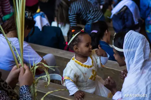 Egyptian Orthodox Christians take part in a mass marking the Palm Sunday at a church in Saint Samaan the tanner Monastery in Cairo on April 1, 2018. Photo by Stringer