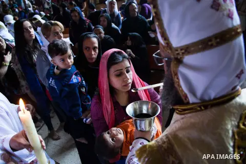 Egyptian Orthodox Christians take part in a mass marking the Palm Sunday at a church in Saint Samaan the tanner Monastery in Cairo on April 1, 2018. Photo by Stringer