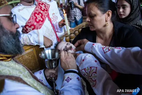 Egyptian Orthodox Christians take part in a mass marking the Palm Sunday at a church in Saint Samaan the tanner Monastery in Cairo on April 1, 2018. Photo by Stringer