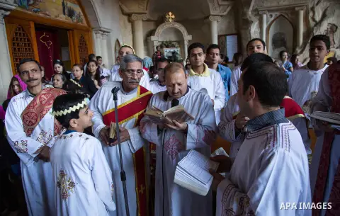 Egyptian Orthodox Christians take part in a mass marking the Palm Sunday at a church in Saint Samaan the tanner Monastery in Cairo on April 1, 2018. Photo by Stringer