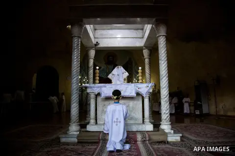 Egyptian Orthodox Christians take part in a mass marking the Palm Sunday at a church in Saint Samaan the tanner Monastery in Cairo on April 1, 2018. Photo by Stringer