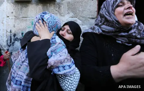 Palestinian women mourn during the funeral of Faris al-Raqib who died from his injuries after being shot in the stomach by Israeli forces a few days earlier, in Khan Yunis, in the southern Gaza Strip on April 2, 2018. Ra...