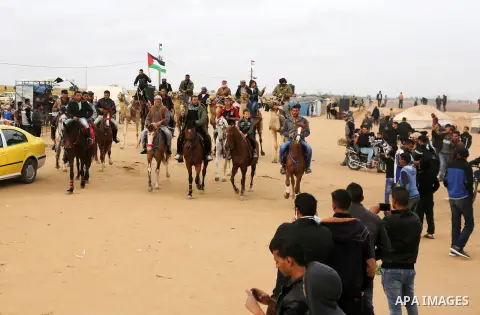 Palestinian men attend a horse race during a tent city protest along the Israel border with Gaza, demanding the right to return to their homeland, in Khan Yunis in the southern Gaza Strip April 3, 2018. Photo by Ashraf A...