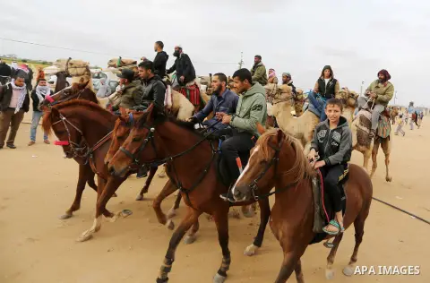Palestinian men attend a horse race during a tent city protest along the Israel border with Gaza, demanding the right to return to their homeland, in Khan Yunis in the southern Gaza Strip April 3, 2018. Photo by Ashraf A...
