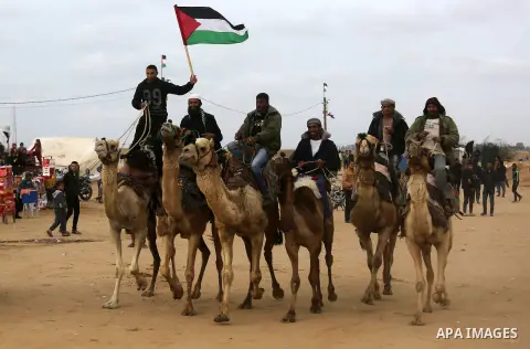 Palestinian men attend a camel race during in a tent city protest along the Israel border with Gaza, demanding the right to return to their homeland, in Khan Yunis in the southern Gaza Strip April 3, 2018. Photo by Ashra...