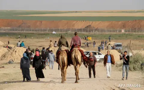 Palestinians ride camels during a tent city protest along the Israel border with Gaza, demanding the right to return to their homeland, in Jabalia in the northern of Gaza strip on April 4, 2018. Photo by Mahamoud Ajour