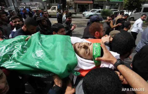 Palestinians carry the body of Mujahid al-Khudari 23, who was killed by Israeli security forces during clashes along Israel border with Gaza, during his funeral, in Gaza city, on April 5, 2018. Photo by Mahmoud Ajour