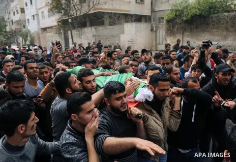 Palestinians carry the body of Mujahid al-Khudari 23, who was killed by Israeli security forces during clashes along Israel border with Gaza, during his funeral, in Gaza city, on April 5, 2018. Photo by Dawoud Abo Alkas