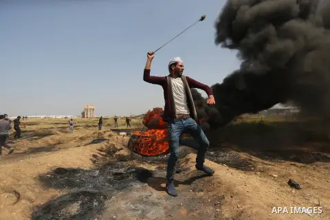 Palestinian protesters clash with Israeli security forces at the Israel-Gaza border during a tent city protest demanding the right to return to their homeland, in east of Gaza city on April 6, 2018. Photo by Dawoud Abo A...