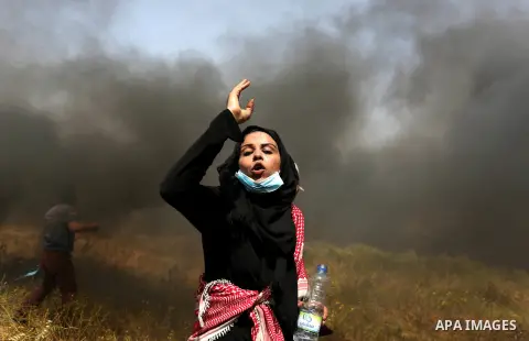Palestinian protesters burn tires to protect themselves from shots of Israeli soldiers during clashes in a tent city protest at the Israel-Gaza border, demanding the right to return to their homeland, in Khan Younis in t...