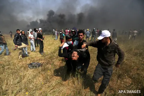 A wounded Palestinian protester is evacuated during clashes with Israeli security forces at the Israel-Gaza border in a tent city protest demanding the right to return to their homeland, in Khan Younis in the southern Ga...