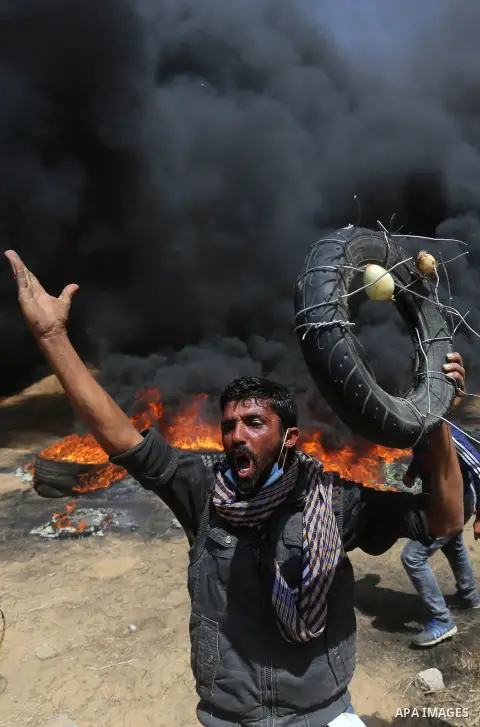 Palestinian protesters gather during clashes with Israeli security forces at the Israel-Gaza border in a tent city protest demanding the right to return to their homeland, in Khan Younis in the southern of Gaza strip on...