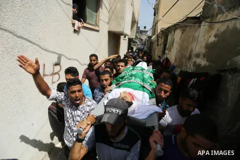 Palestinian mourners carry the body of Alaa al-Zamili, 15, who who died the day before during clashes with Isareli security forces at the Israel-Gaza border, during his funeral in Rafah in the southern Gaza strip on Apri...