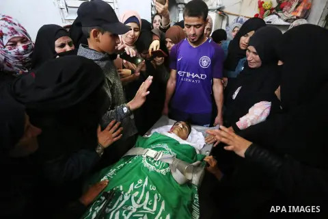 Relatives mourn over the body of Alaa al-Zamili, 15, who who died the day before during clashes with Isareli security forces at the Israel-Gaza border, during his funeral in Rafah in the southern Gaza strip on April 7, 2...