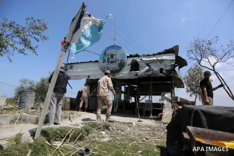 Members of Hamas movement's security apparatus inspect the site targeted by Israeli tank fire on the outskirts of Gaza City, near the border with Israel, on April 11, 2018. Israeli tanks shelled sites in eastern Gaza Cit...