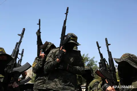 Palestinian militants from the Al-Quds Brigades, the armed wing of the Islamic Jihad movement attend the funeral of their comrades who were killed in an explosion in the previous day, in Rafah in the southern Gaza Strip...