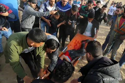 A picture taken on April 17, 2018, shows A wounded Palestinian Abdel-Rahman Nofal, is evacuated during clashes with Israeli security forces in a tent city protest where Palestinians demand the right to return to their ho...