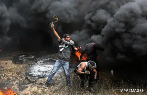 Palestinian protesters gather during clashes with Israeli security forces at tents protest at the Israel-Gaza border where Palestinians demand the right to return to their homeland, in Khan Younis in the southern Gaza St...
