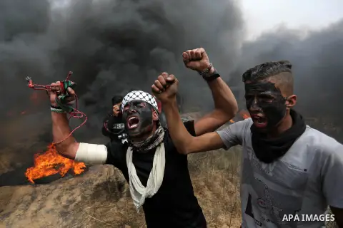 Palestinian protesters shout slogans during clashes with Israeli security forces at tents protest at the Israel-Gaza border where Palestinians demand the right to return to their homeland, in Khan Younis in the southern...