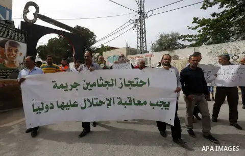Palestinians hold banners during a demonstration demanding that Israeli authorities return the bodies of Palestinians killed during attacks on Israel, in the West Bank town of Bethlehem on April 20, 2018. Photo by Wisam...