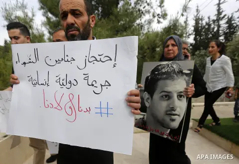 Palestinians hold banners during a demonstration demanding that Israeli authorities return the bodies of Palestinians killed during attacks on Israel, in the West Bank town of Bethlehem on April 20, 2018. Photo by Wisam...