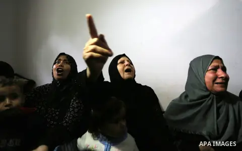 Relatives of Palestinian 29-year-old Saadi Abu Taha, who was killed at the Israel-Gaza border during clashes with Israeli security forces, mourn during his funeral in Khan Yunis in the southern Gaza strip on April 21, 20...