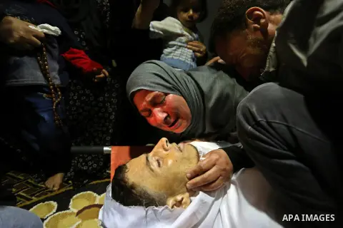 Relatives of Palestinian 29-year-old Saadi Abu Taha, who was killed at the Israel-Gaza border during clashes with Israeli security forces, mourn over his body during his funeral in Khan Yunis in the southern Gaza strip o...