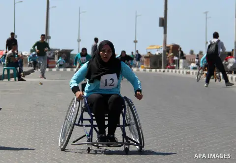 Disabled Palestinian women take part in world education week marathon in Gaza seaport, on April 23, 2018 in Gaza city. Photo by Mahmoud Ajour