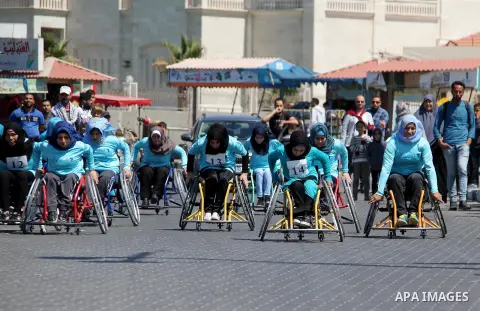Disabled Palestinian women take part in world education week marathon in Gaza seaport, on April 23, 2018 in Gaza city. Photo by Mahmoud Ajour