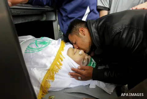 Palestinians mourn over the body of Palestinian Abdullah al-Shamali, 20, who was died of from his injuries, after he was shot by Israeli security forces during clashes last Friday, at a morgue in hospital in Rafah in the...