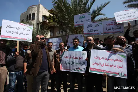 Palestinian Authority employees in the Gaza Strip take part in a protest demanding their salaries in front of the headquarters of the Council of Ministers, in Gaza city on April 24, 2018. Photo by Mahmoud Ajour