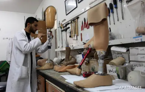 A Palestinian staff member prepares a prosthetic leg at Gaza's Artificial Limbs and Polio Center (ALPC) in Gaza City on April 24, 2018. According to Gaza health ministry, 17 Palestinians had limbs amputated during clashe...