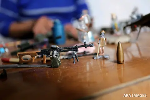 Palestinian artist Magdy Abu Takeya, 38, converts gunshots used by the Israeli security forces against Palestinian protesters to small pieces of art knows as "Art of thumbnails" at his house in Nuseirat in the central Ga...