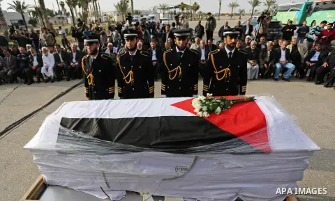 Members of the Palestinian Hamas security forces stand next to the coffin containing the body of Palestinian scientist Fadi al-Batsh, assassinated in Malaysia, in the Rafah border crossing in the southern Gaza Strip on A...