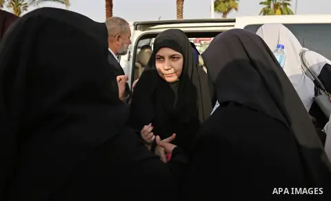 The wife of Palestinian scientist Fadi al-Batsh, who was assassinated in Malaysia, is hugged upon her husband's body arrives at the Rafah border crossing in the southern Gaza Strip on April 26, 2018, after his body was r...