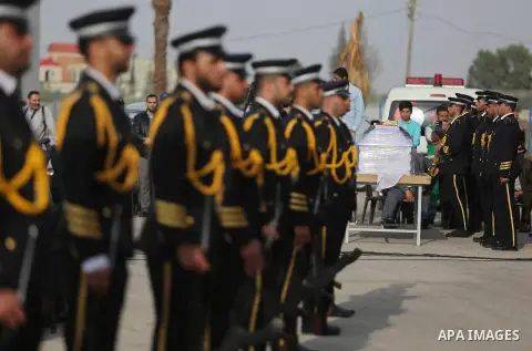 Members of the Palestinian Hamas security forces stand next to the coffin containing the body of Palestinian scientist Fadi al-Batsh, assassinated in Malaysia, in the Rafah border crossing in the southern Gaza Strip on A...