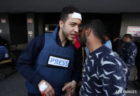 A Palestinian journalist who was wounded during clashes between Palestinian protesters and Israeli security forces at the Israel-Gaza border, leaves hospital after he was receiving treatment, in Gaza city on April 27, 20...