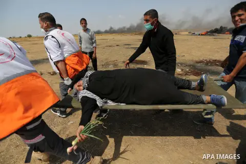 A wounded Palestinian woman is evacuated during clashes with Israeli security forces during tents protest demanding the right to return to their homeland, at the Israel-Gaza border, in Khan Younis in the southern Gaza St...