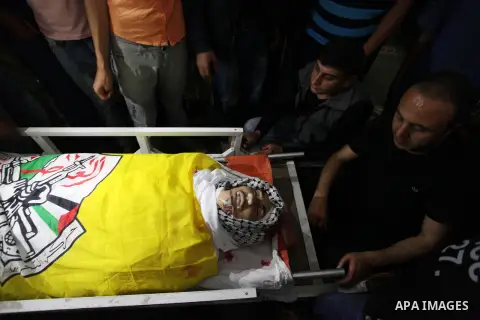 Relatives of Palestinian Khalil Atallah, 25, who was shot dead by Israeli security forces during clashes at the Israel-Gaza border, mourn over his body during his funeral in Gaza city, on April 28, 2018. Photo by Mahmoud...