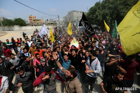 Mourners carry the body of 15-year-old Palestinian teenager Azzam Oweida who was died of his injuries sustained by Israeli security forces during clashes at the Israel-Gaza border, during his funeral in Khan Yunis in the...