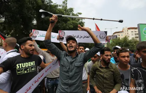 Palestinian labors chant slogans during a protest against the continued Israeli siege and the spread of unemployment to mark the International Labor Day, in front of the headquarters of the Council of Ministers, in Gaza...