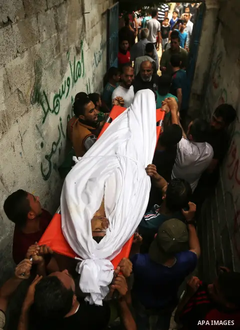 Palestinians carry the body 19-year-old Palestinian teenager Anas Abu aser who was died of his injuries sustained by Israeli security forces during clashes at the Israel-Gaza border, during his funeral in Gaza city on Ma...