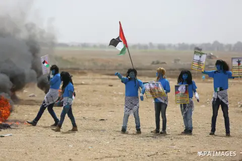 Palestinian protesters dressed as a character from the movie "Avatar" take part in a protest demanding the right to return to their homeland, at the Israel-Gaza border in Khan Younis in the southern Gaza Strip, May 3, 20...
