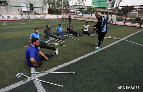 Disabled Palestinians who were lost their limbs participate in football training, in Gaza City on May 10, 2018. Photo by Mahmoud Ajour