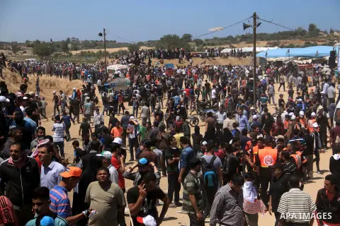 Palestinian protesters gather during clashes with Israeli security froces in a tent city protest where Palestinians demand the right to return to their homeland, on the occasion of the 70th anniversary of the "Nakba", an...