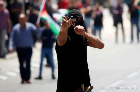 Palestinian protesters gather during clashes with Israeli security forces following a protest against U.S. embassy move to Jerusalem and on the occasion of the 70th anniversary of the "Nakba" or "catastrophe", in the Wes...