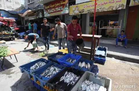 A Palestinian vendor sells fish at a market during the holy month of Ramadan, on May 24, 2018. Ramadan is sacred to Muslims because it is during that month that tradition says the Koran was revealed to the Prophet Mohamm...